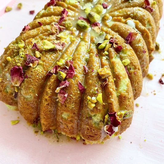 This keto-friendly Pistachio Rose Water Cake recipe is as delicious as it is gorgeous. Moist and flavorful, it is drenched in home made syrup and adorned with crushed pistachios & rose petals.